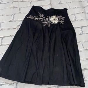 Black skirt with black and white floral detail just below the waist line